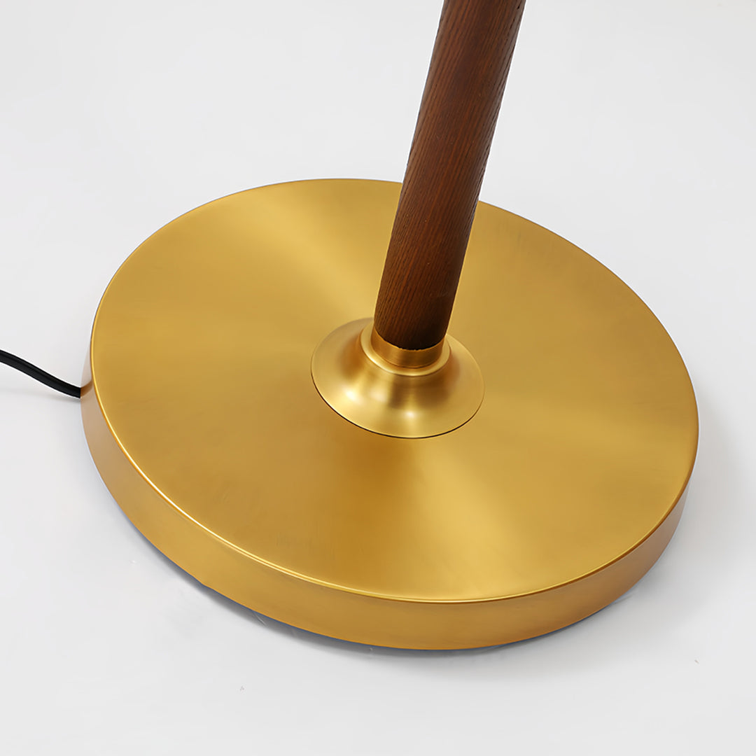 Close-up view of walnut floor lamp base showing brass construction and wooden stem detail