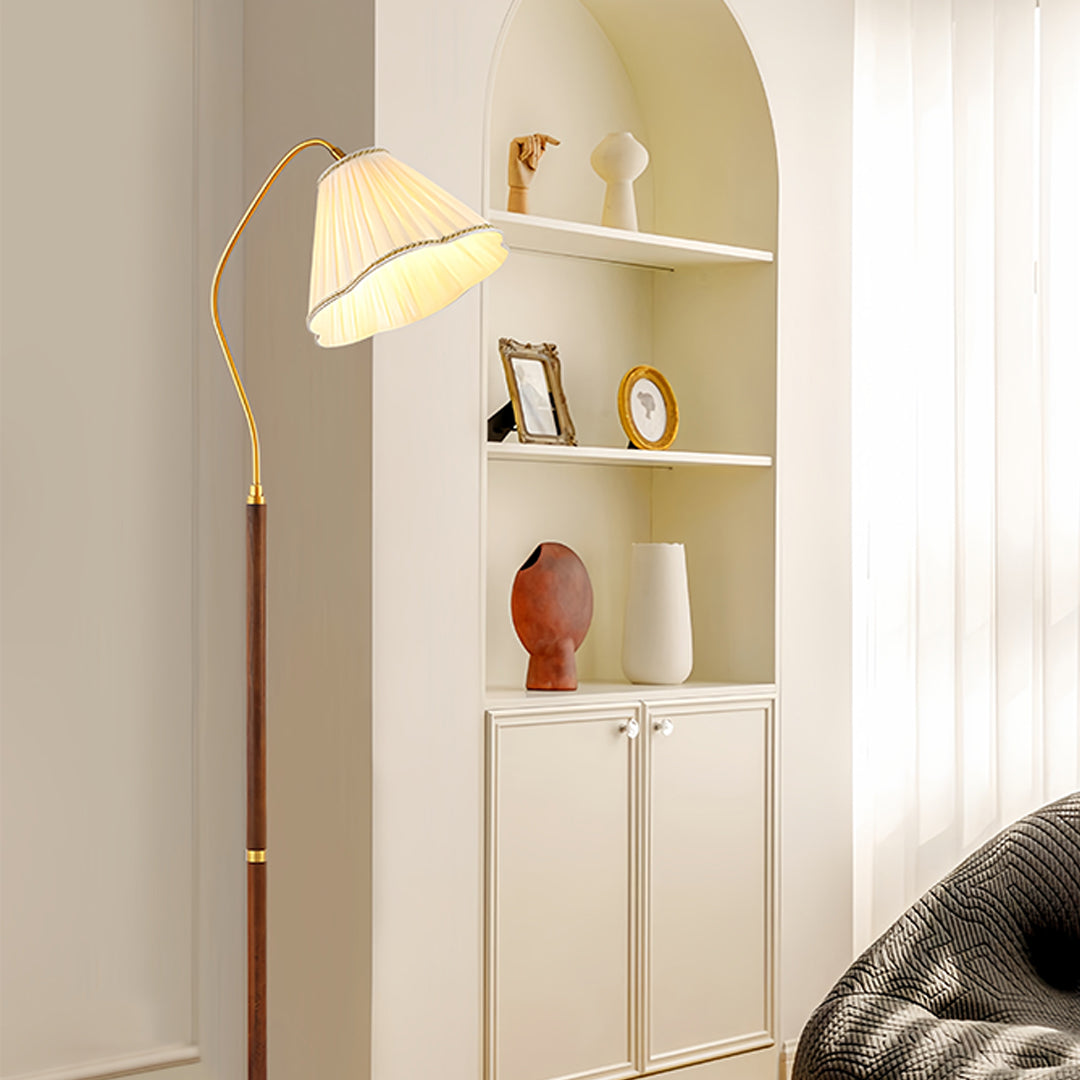Walnut floor lamp positioned next to white cabinet creating ambient lighting atmosphere