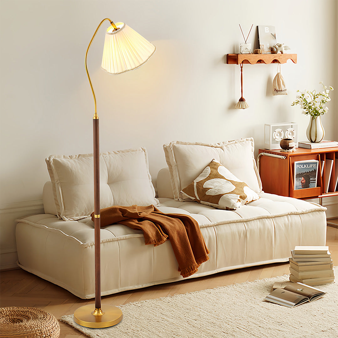 Walnut floor lamp in modern living room setting with cozy sofa and decorative elements