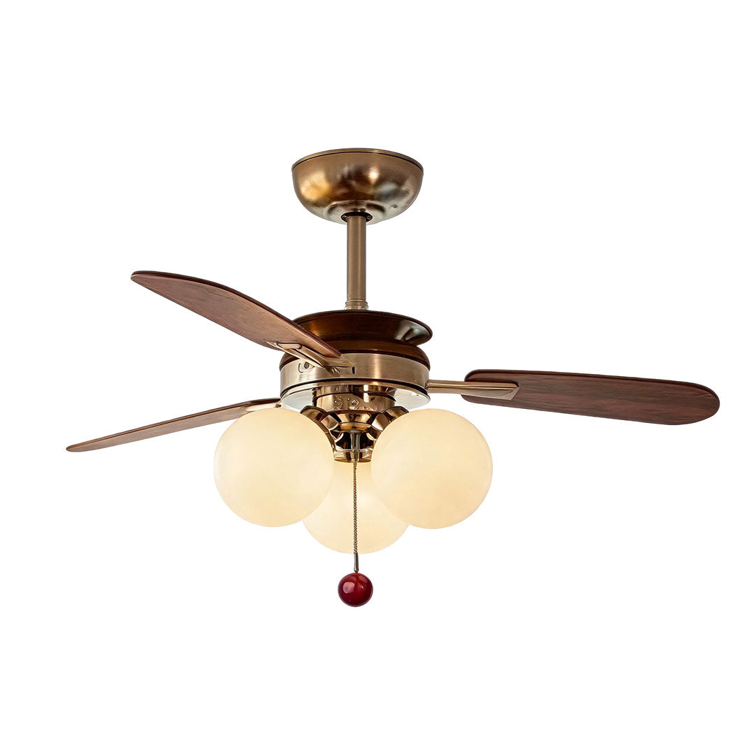 Indoor ceiling fan with light featuring walnut blades, polished bronze hardware, and four globe lights.