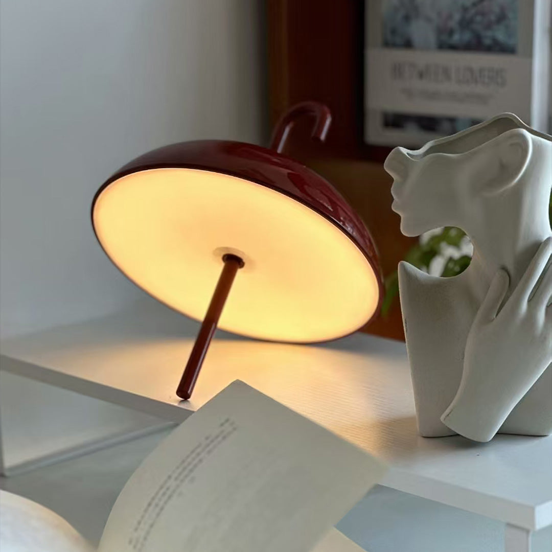 Warm-toned USB rechargeable table lamp creating ambient lighting in interior setting