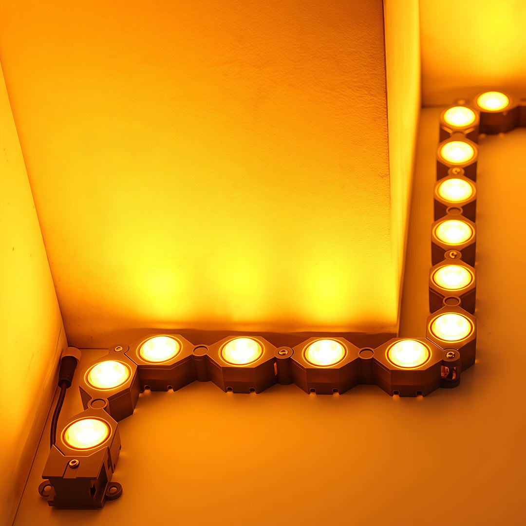 Warm DIY wall wash lighting with glass shade chandelier design creating ambient glow on vintage marquee frame.