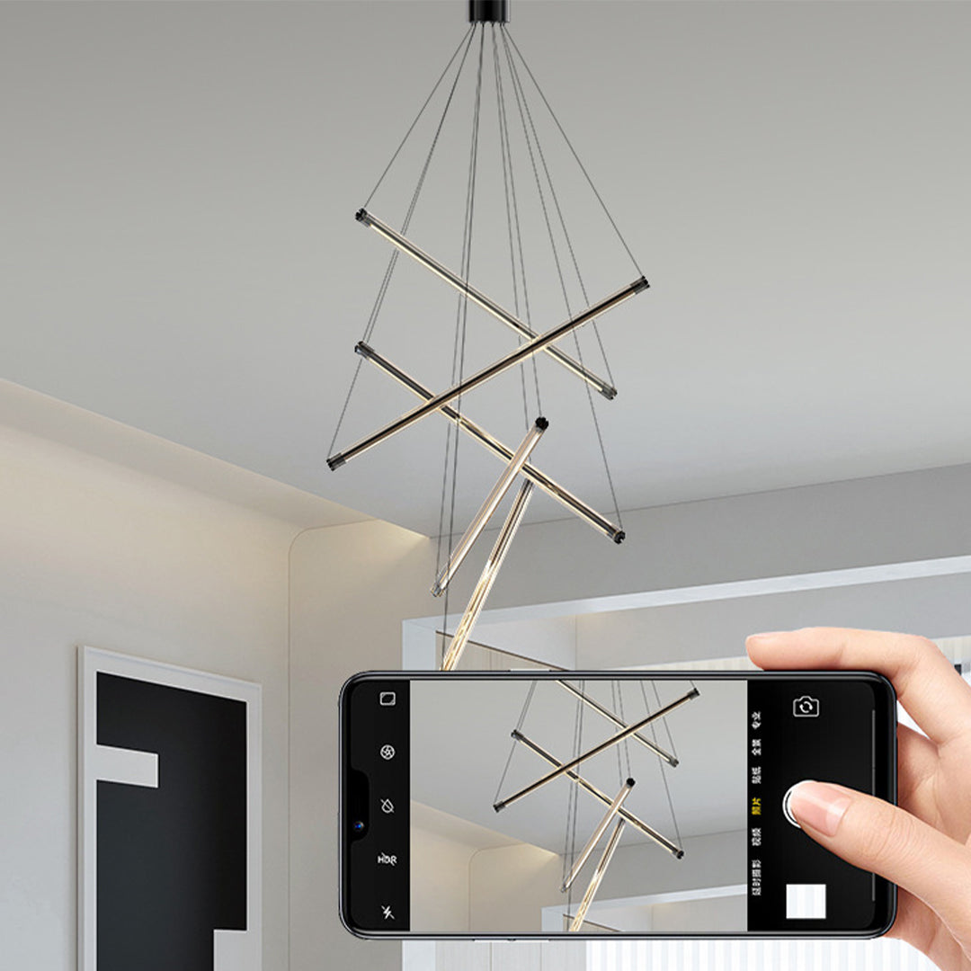Designer LED linear chandelier with warm finish creating inviting atmosphere in modern dining room