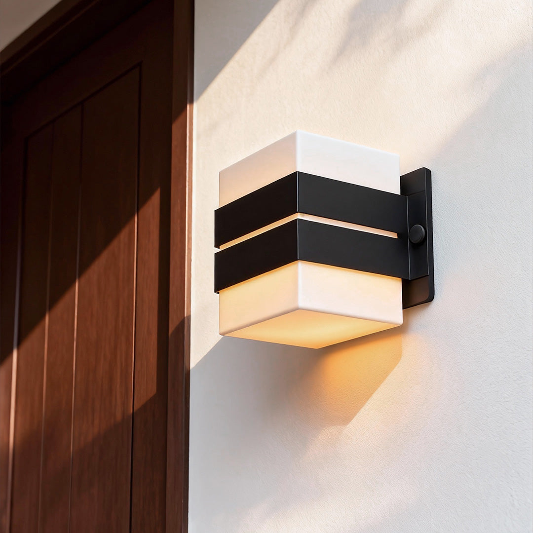 Warm-glow outdoor wall sconce lighting mounted on wood exterior wall with modern striped design.
