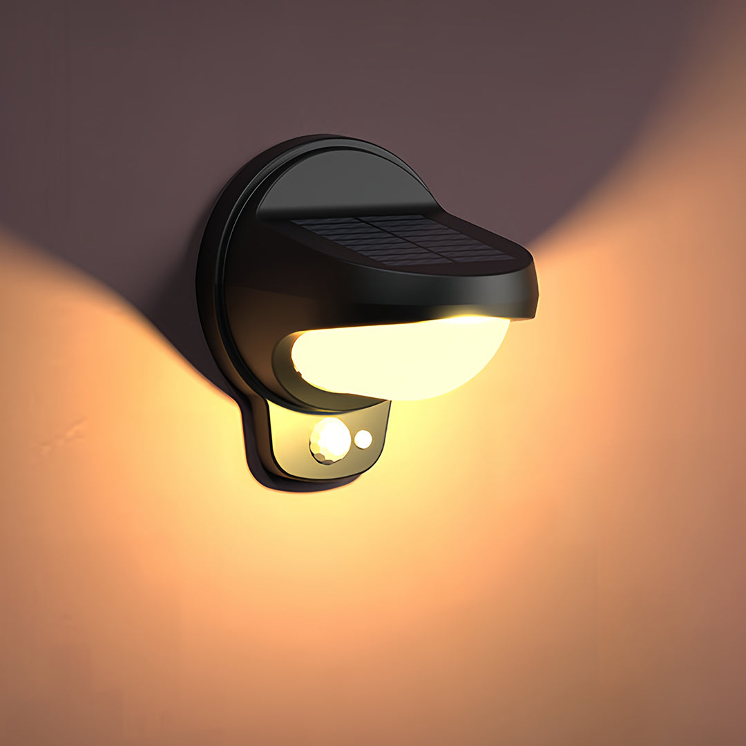 Vintage outdoor wall lights casting warm glow on textured wall surface.