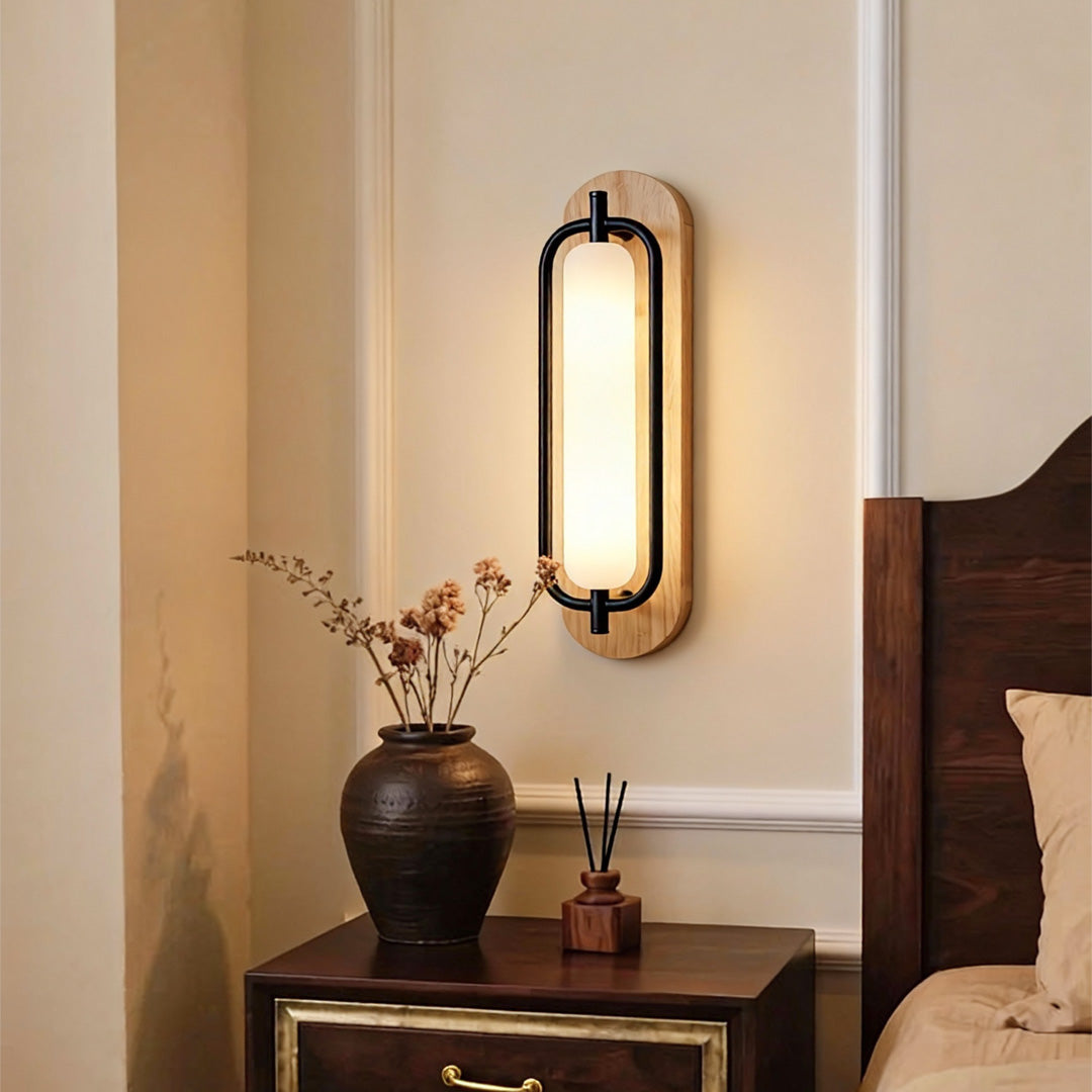 Wall mount outdoor solar lights installed beside a bedroom nightstand with warm glow.