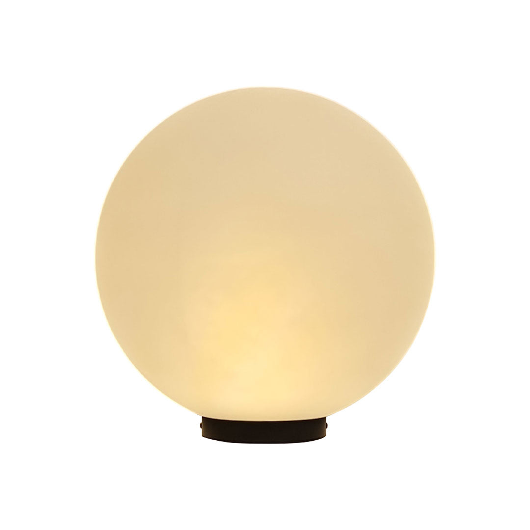 Warm glowing round landscape lighting globe fixture isolated on a clean white background!!