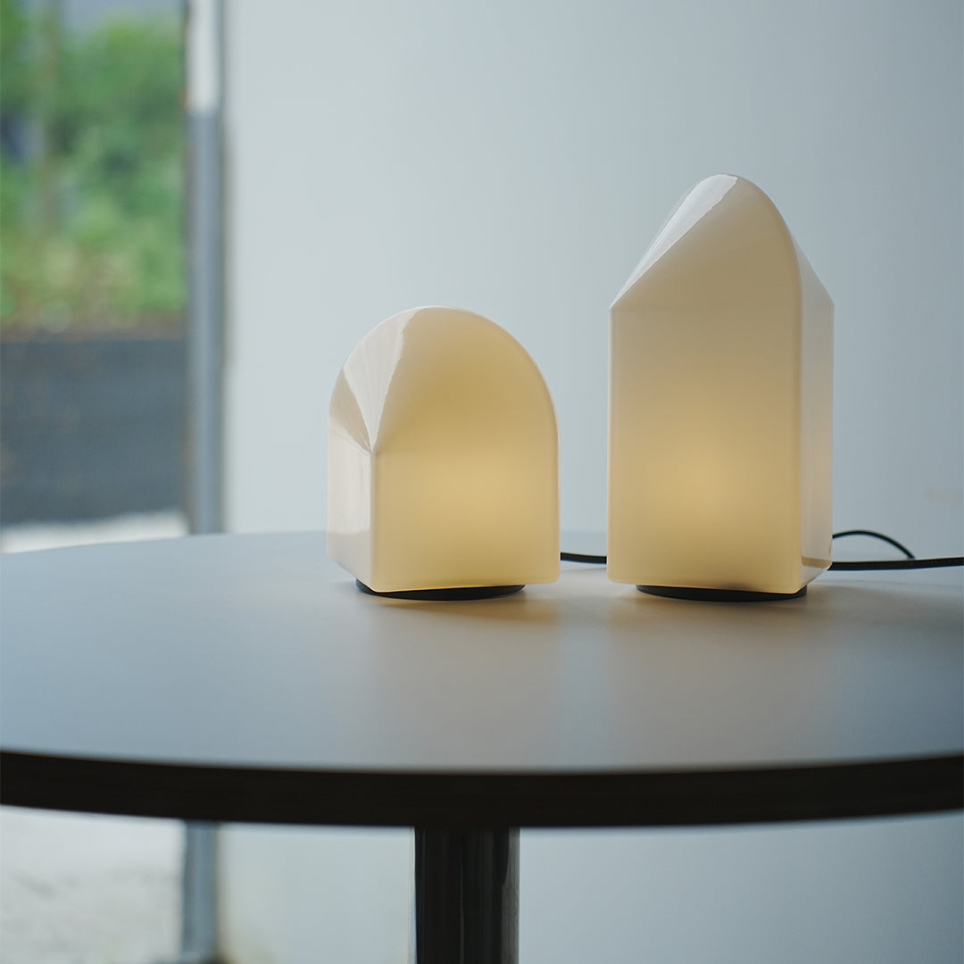 Warm ambient house modern white table lamps lighting up a modern living room.