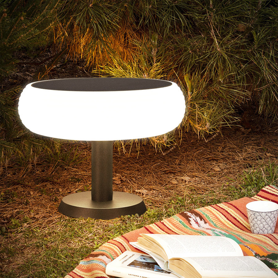 Warm LED mushroom light creating cozy atmosphere for outdoor dining and entertainment area