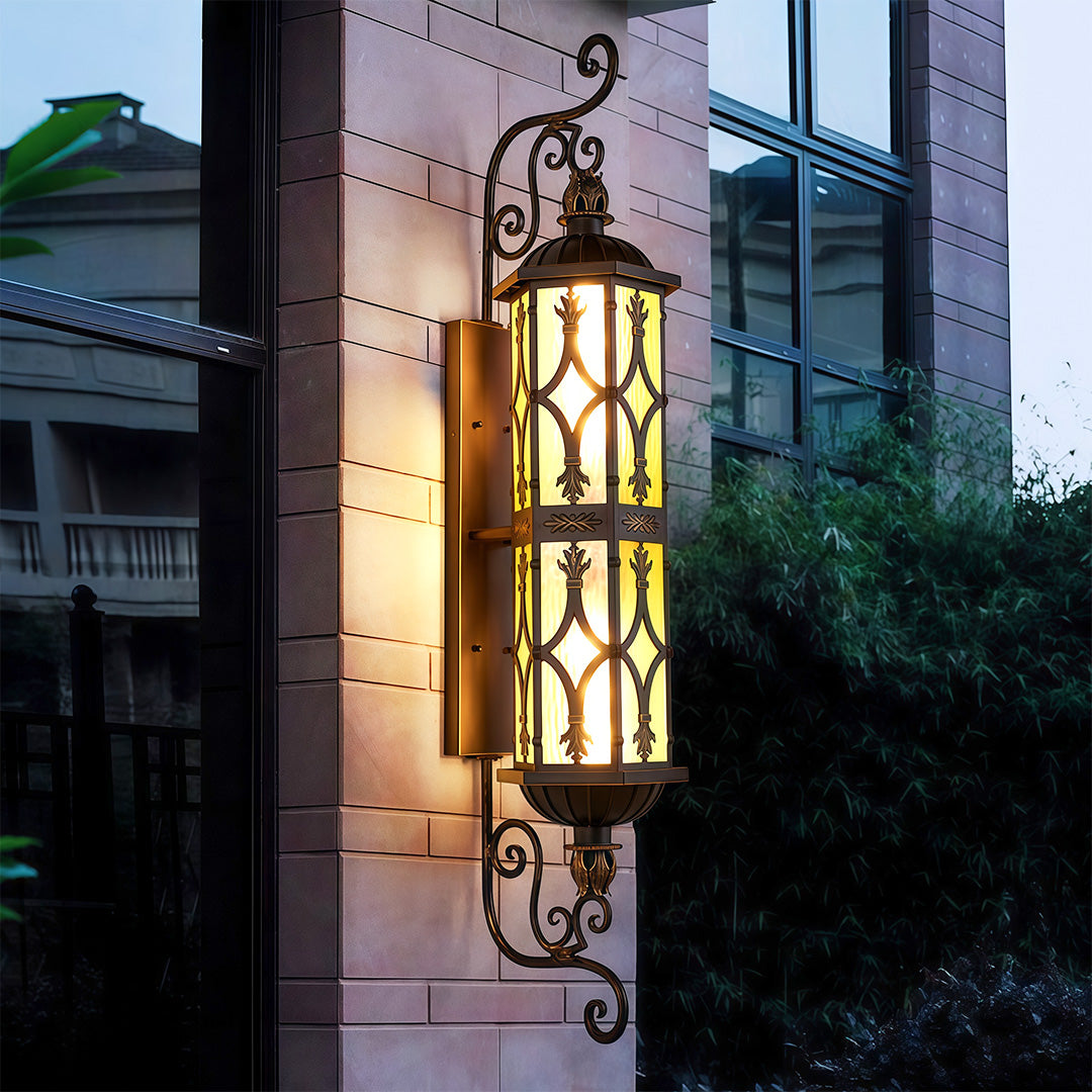 Warm LED wall light fixture with vintage accents illuminating the exterior of a home.