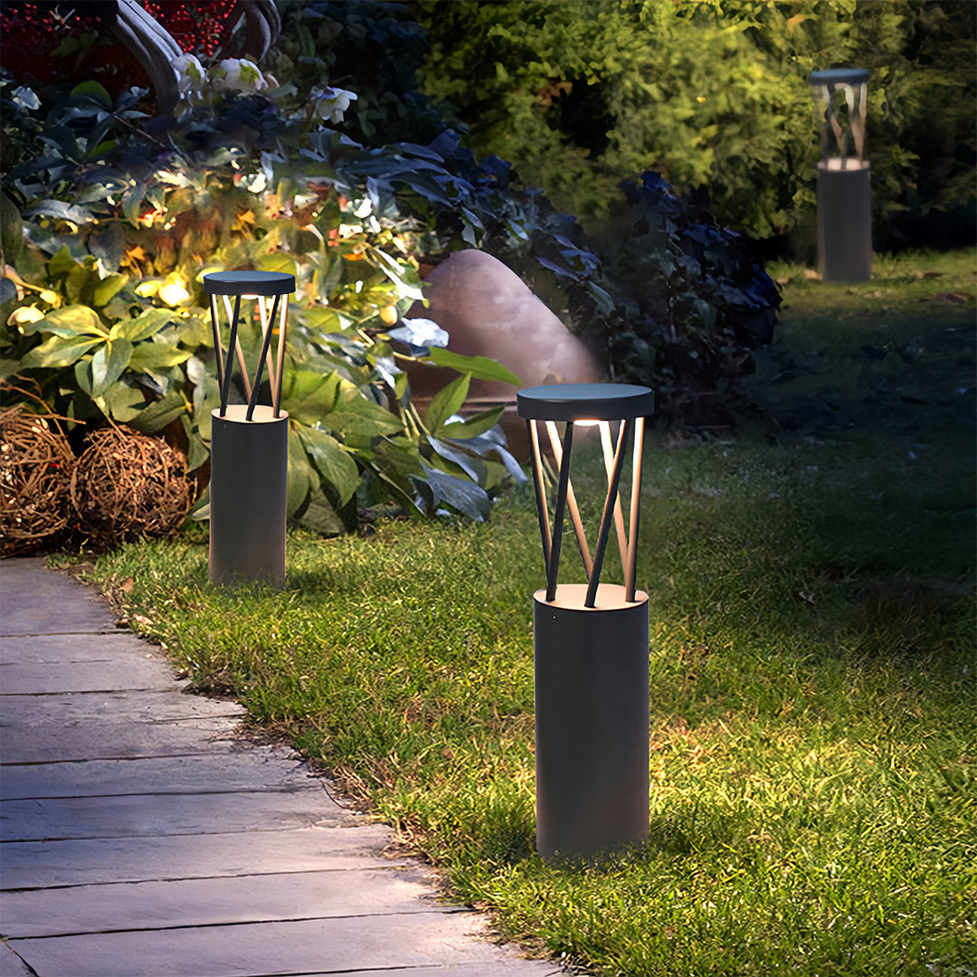 Warm-toned bright path lights standing tall along a curving garden path, designed for all-weather outdoor use.