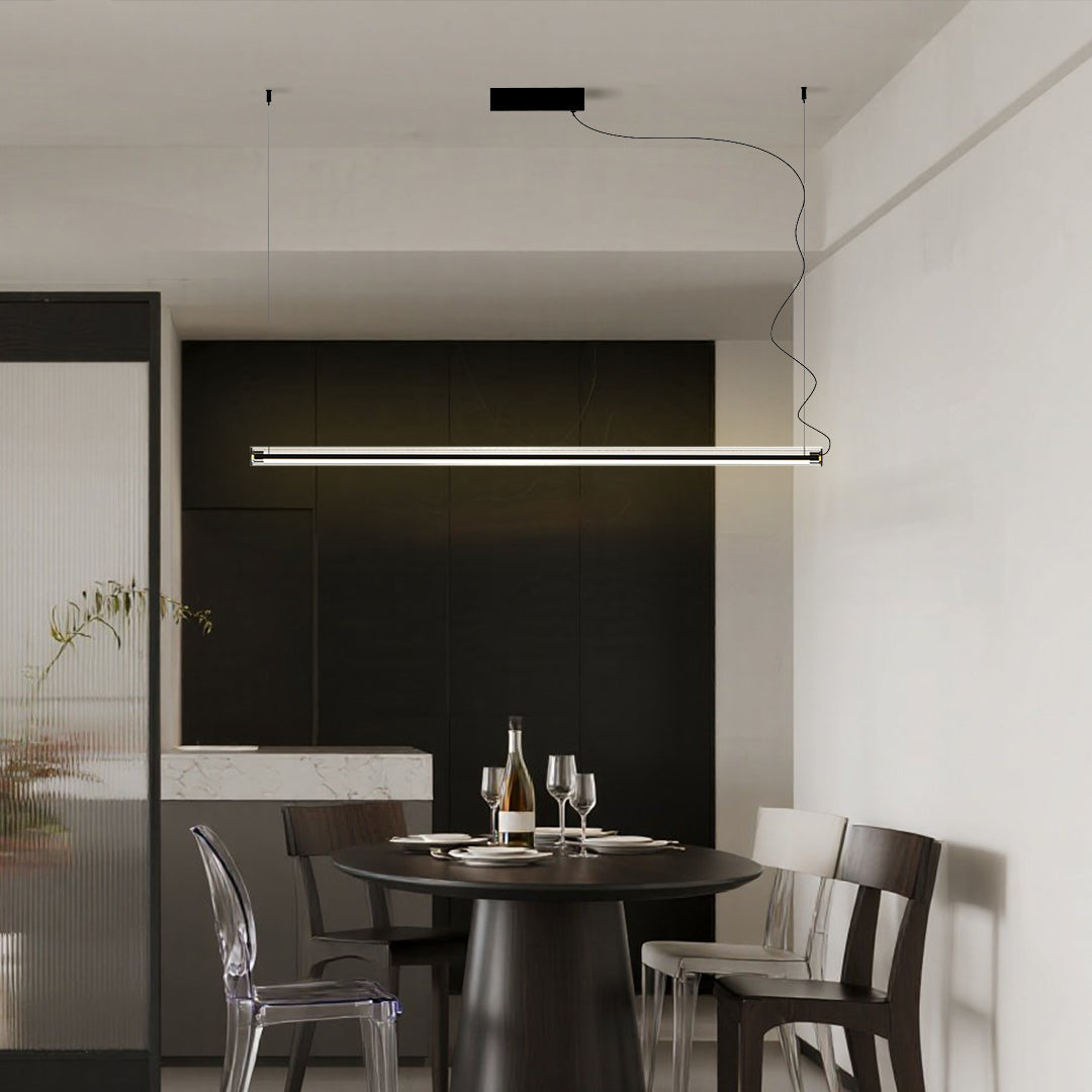 Minimalist linear pendant light with warm tone finish creating cozy dining atmosphere
