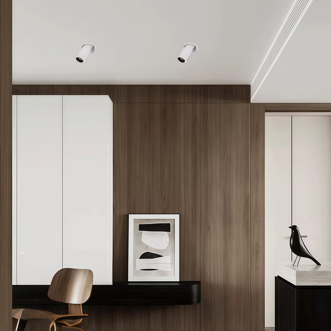 Warm-toned adjustable LED ceiling spotlights featuring glass shade chandelier styling creating ambient glow on colorful wall art.