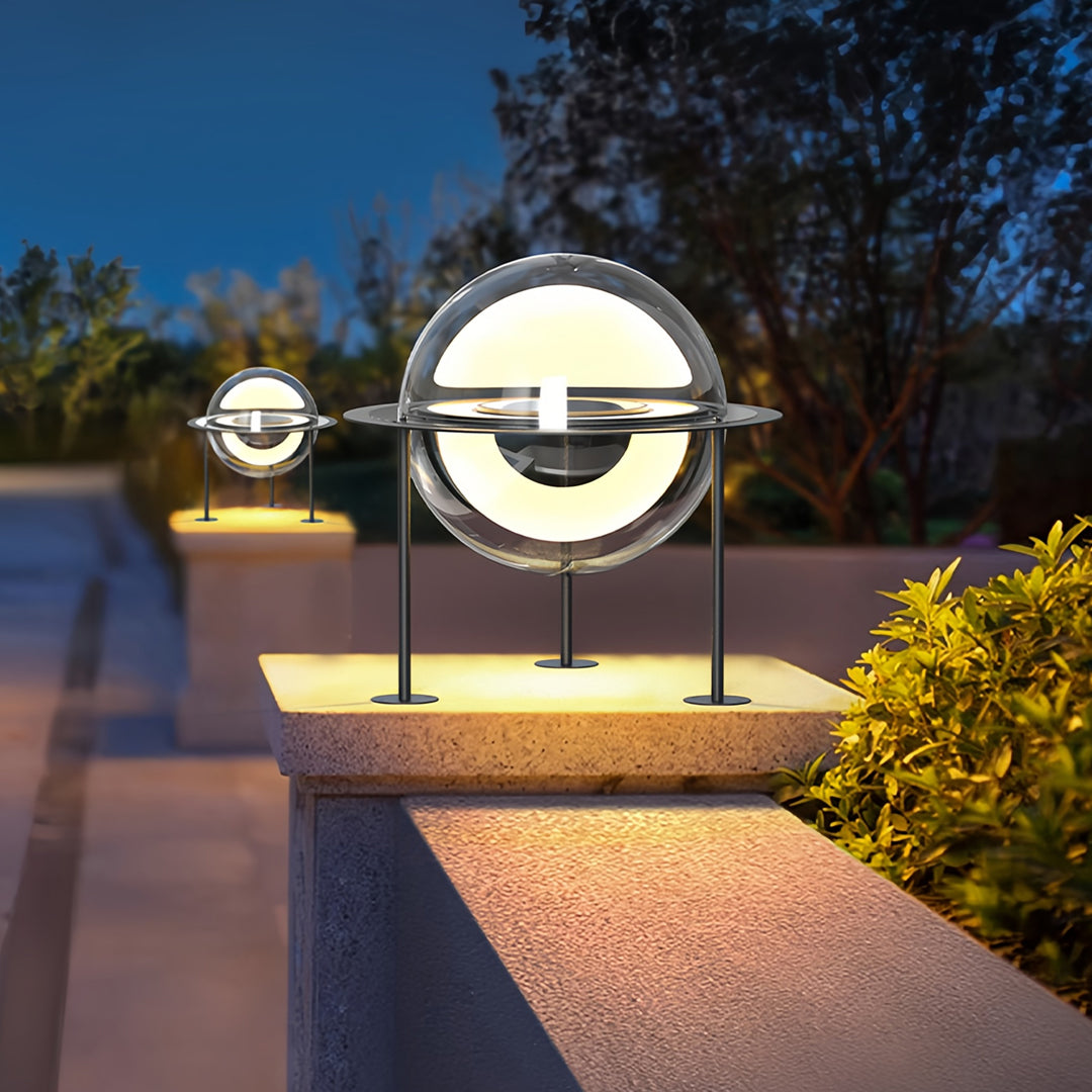Warm-toned outdoor setting with circular main gate pillar light design highlighting pathway and garden edges.