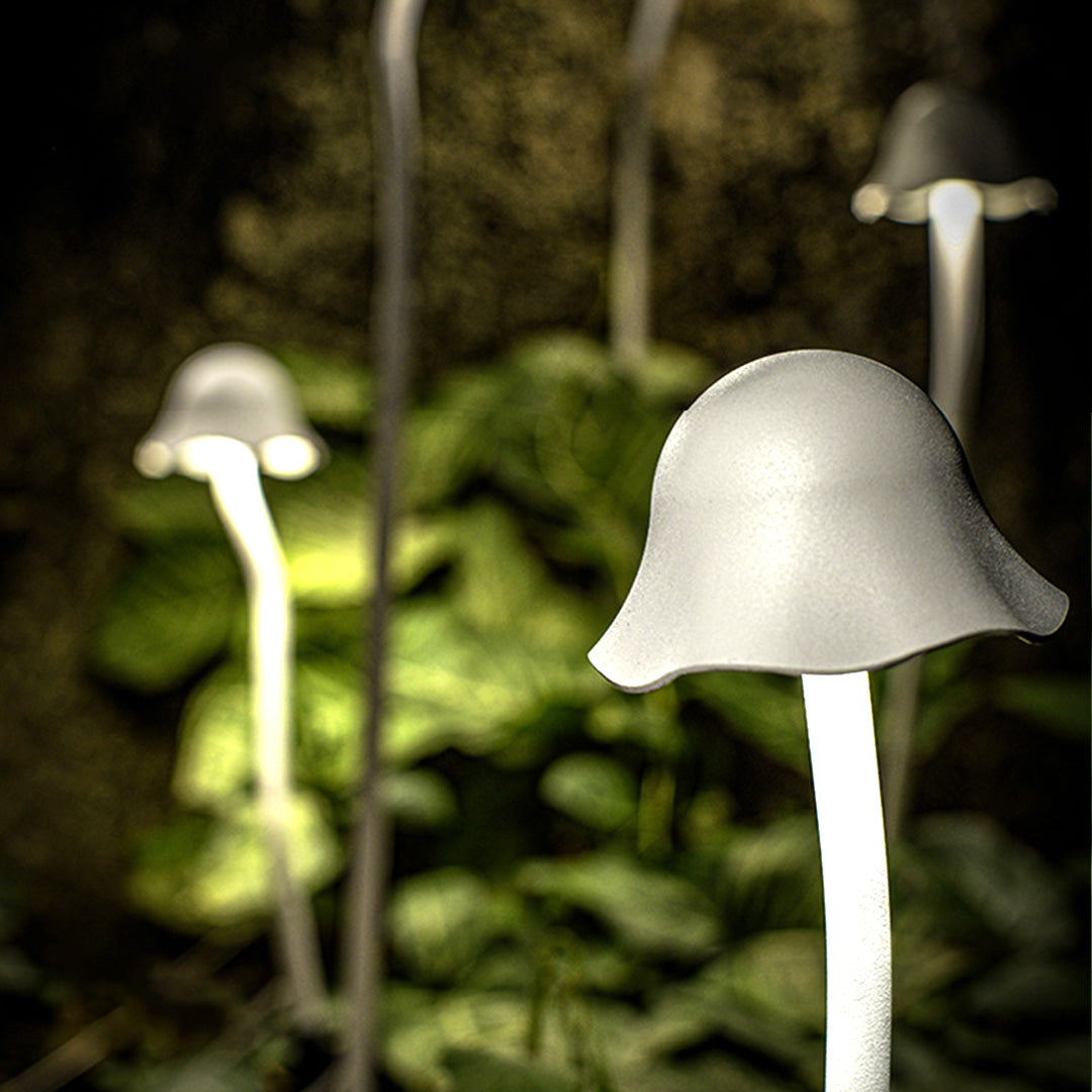 Warm-lit outdoor landscape light with traditional bell design creating cozy ambiance in evening garden setting