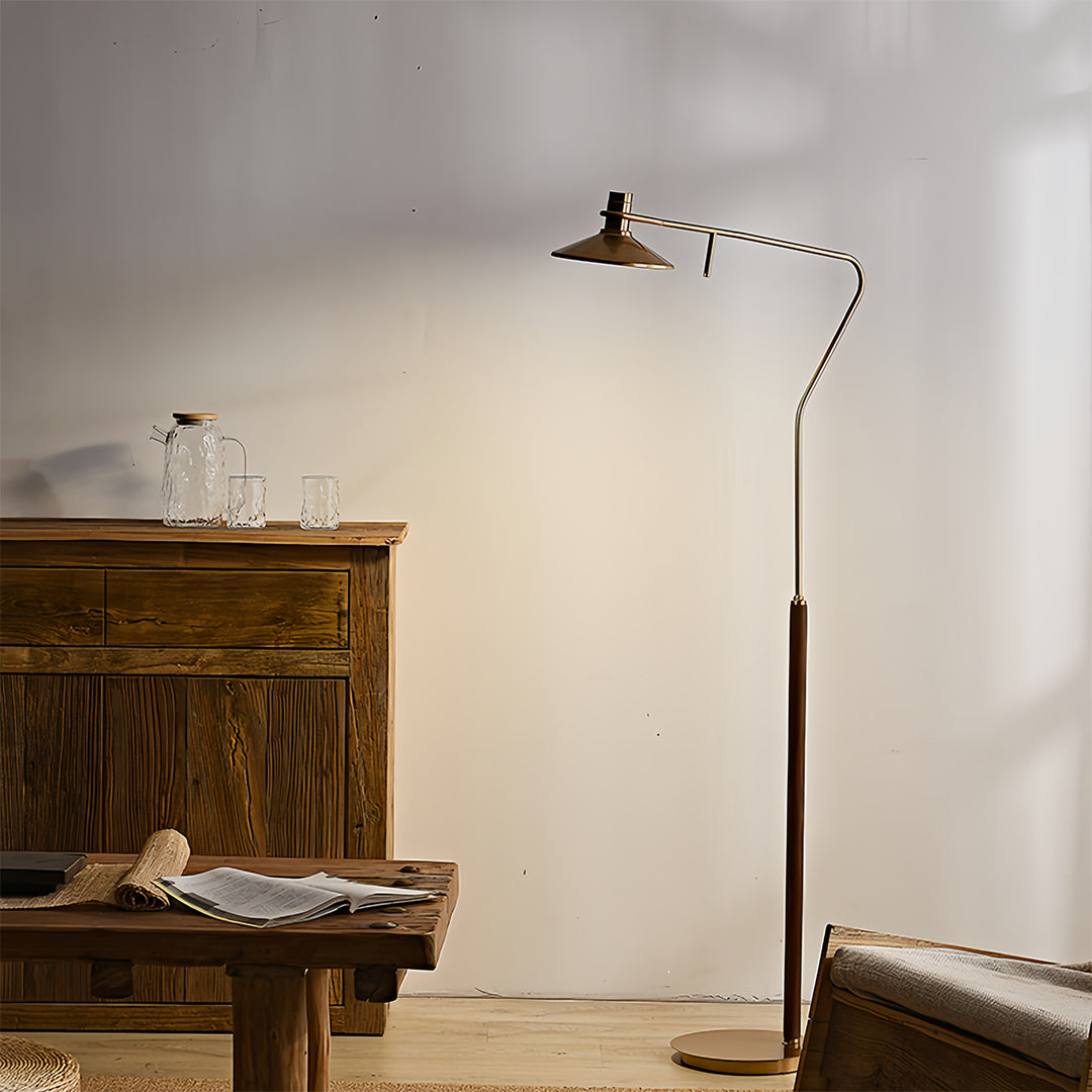 Warm-lit vintage gold floor lamp creating intimate atmosphere in traditional bedroom with exposed brick and wood elements