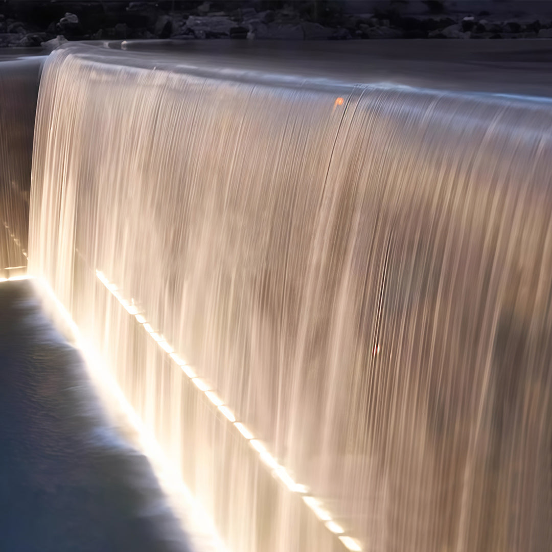 Warm white LED linear wall washer light illuminating a cascading waterfall.