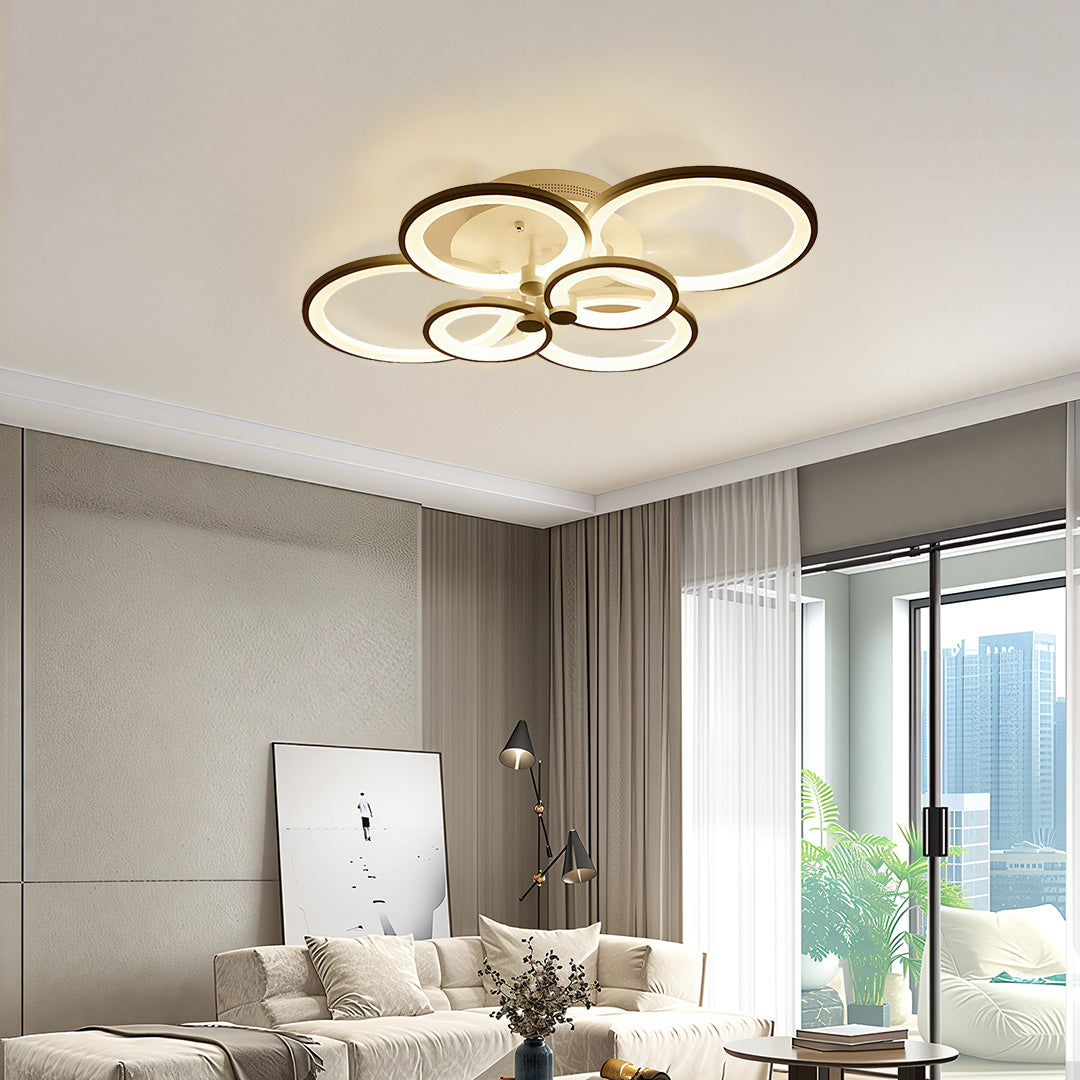 Neutral tone living room accented with warm white multi ring ceiling lights for cozy atmosphere.