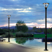 Waterfront lighting installation with decorative lamp posts reflecting in calm water at twilight