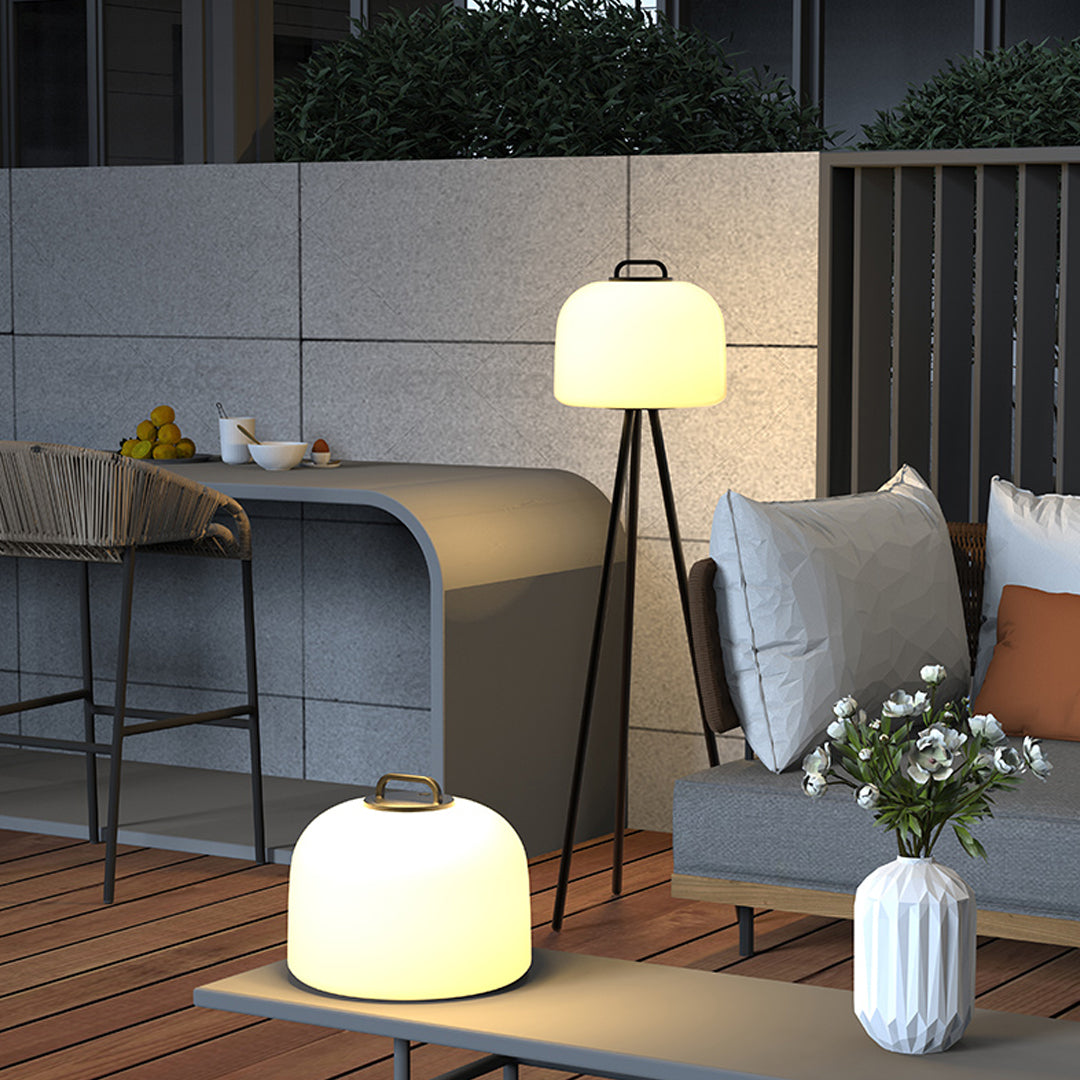 Cozy patio setup illuminated by waterproof outdoor floor lamps placed around seating area.