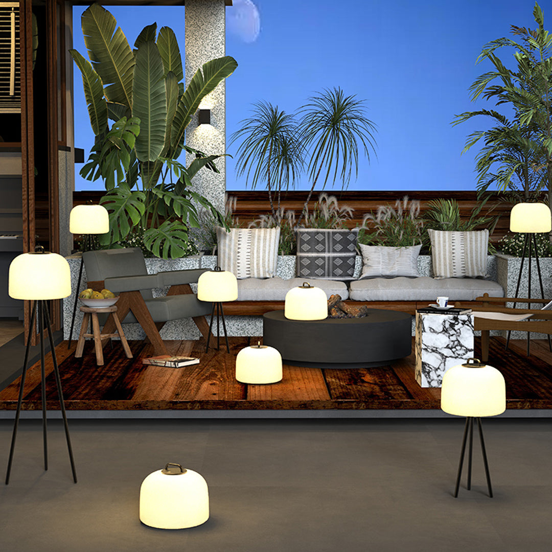 Outdoor lounge decorated with multiple waterproof outdoor floor lamps providing soft ambient lighting.