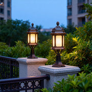 Pair of waterproof outdoor pendant lights illuminating stone pillars on residential balcony at twilight