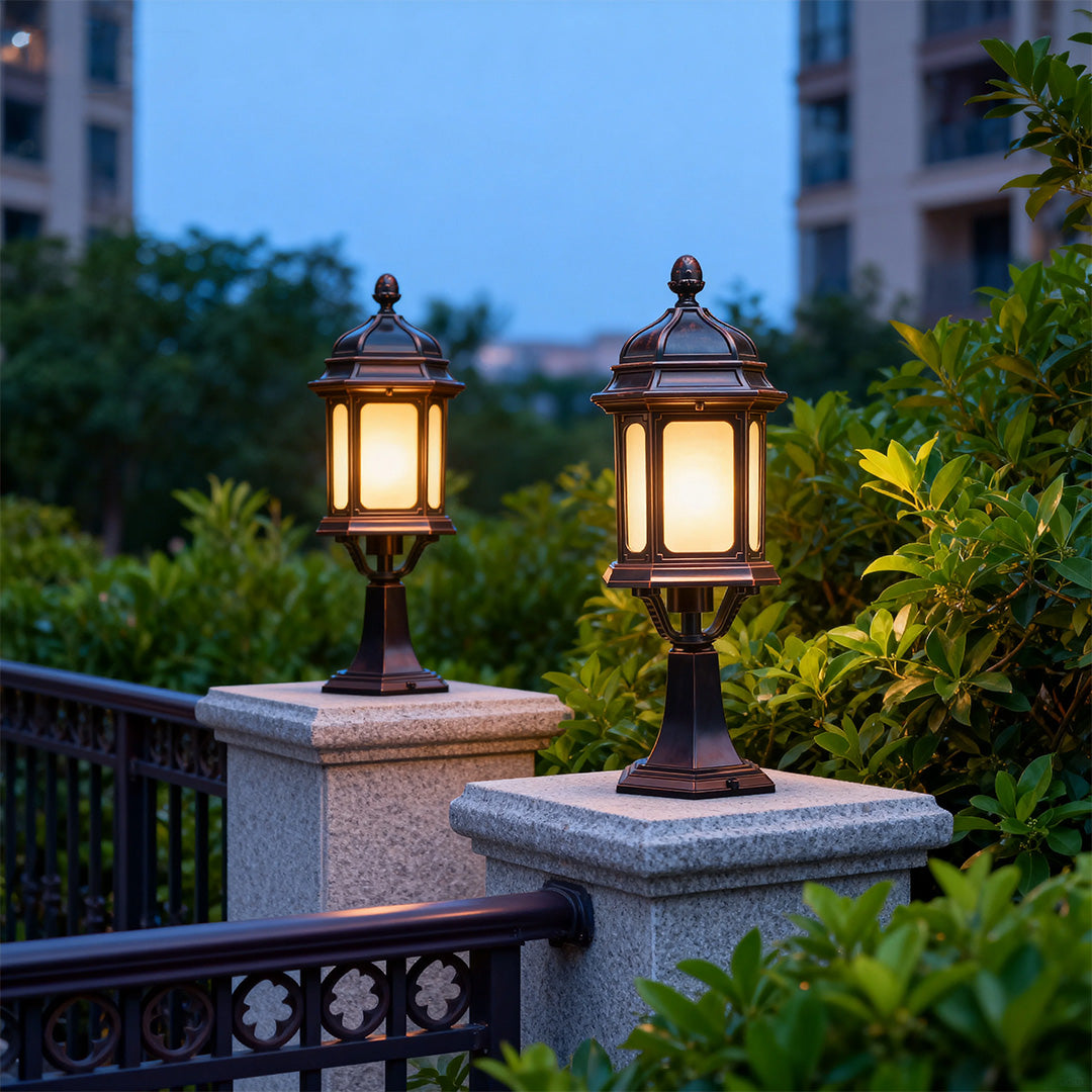 Pair of waterproof outdoor pendant lights illuminating stone pillars on residential balcony at twilight