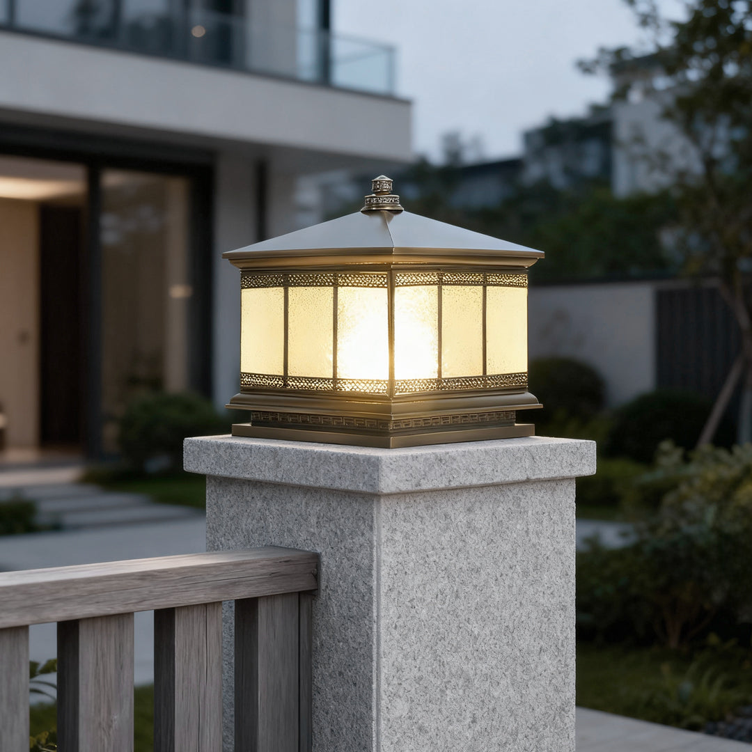 Waterproof outdoor pillar light illuminating a modern fence entrance during evening hours.
