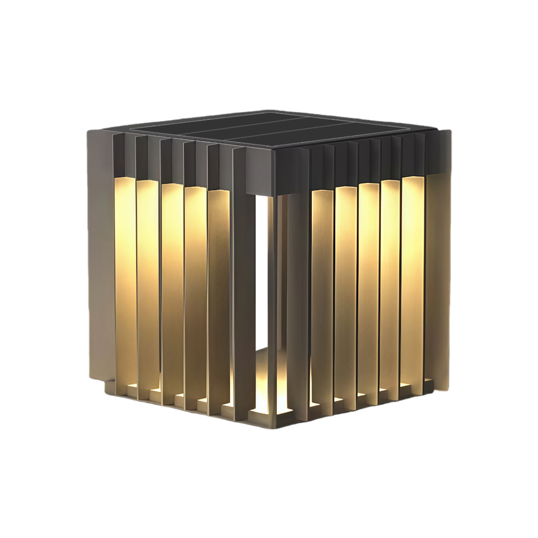 A glowing waterproof outdoor pillar light in a compact cube form with a sleek vertical-grid design for landscape accents.