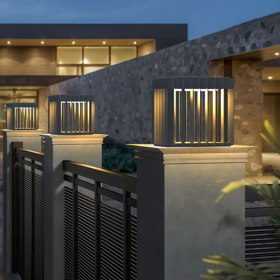 A modern architectural scene showcasing waterproof outdoor pillar lights installed along a contemporary home entrance.