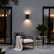 Waterproof outdoor porch lights illuminating a cozy patio seating area with warm glow.