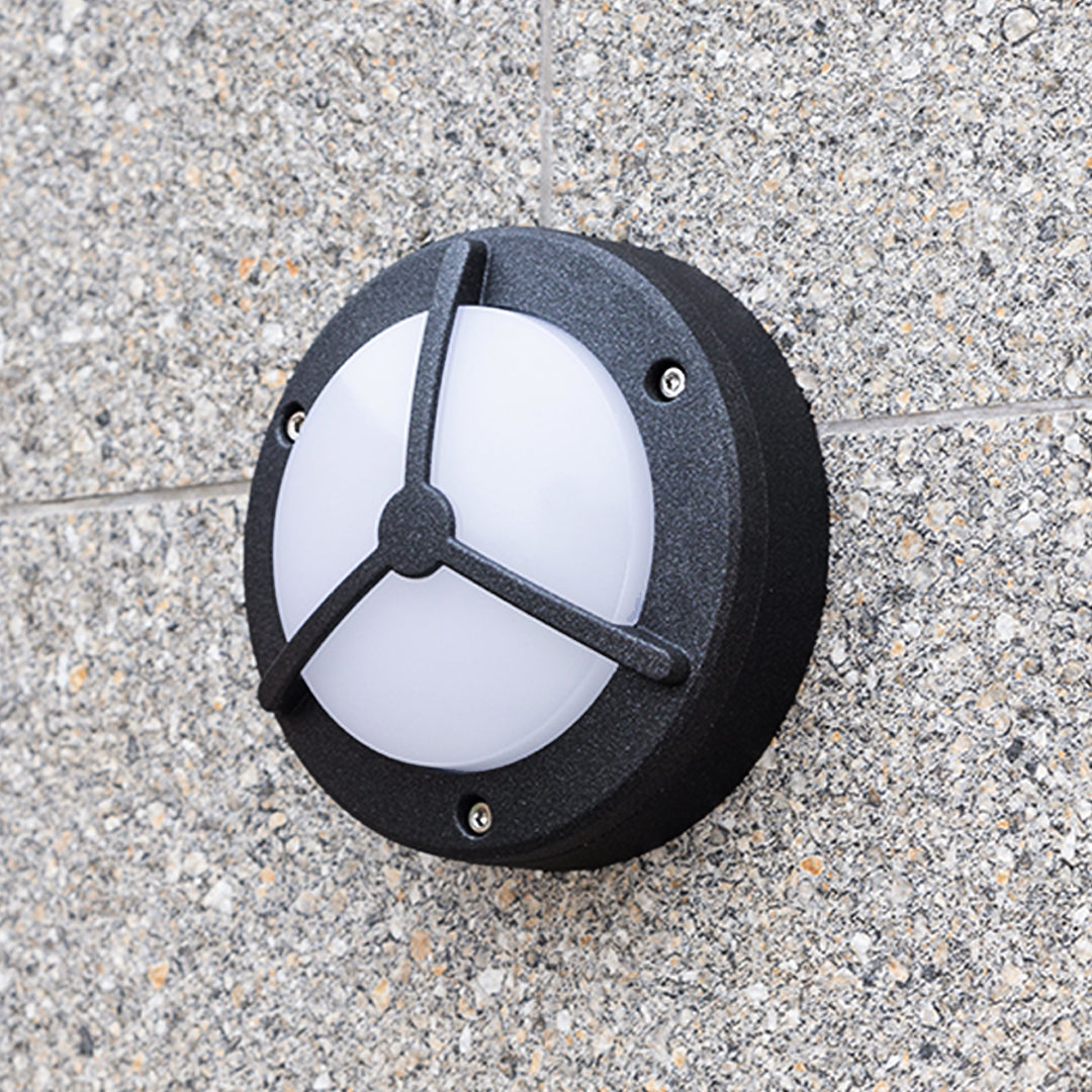 Waterproof outdoor wall lighting mounted on grey granite surface displaying modern circular design