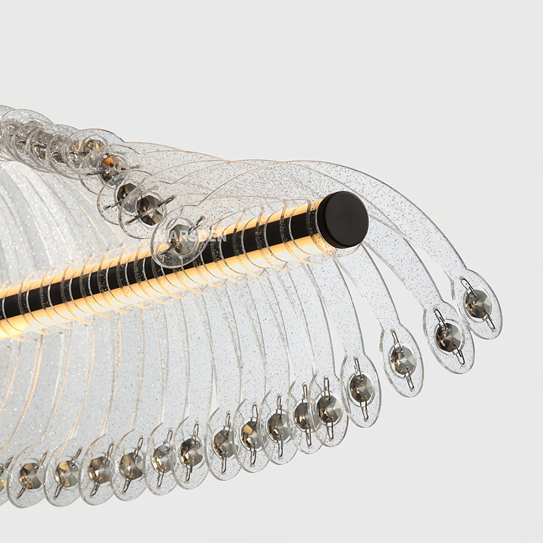 Elegant spiral chandelier displaying wave-like crystal formation suspended over kitchen island with modern appeal