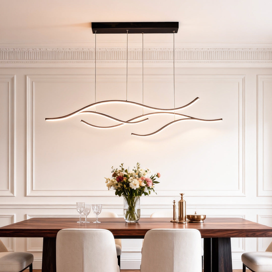Wave-style curved LED pendant light with black canopy in a modern dining room.