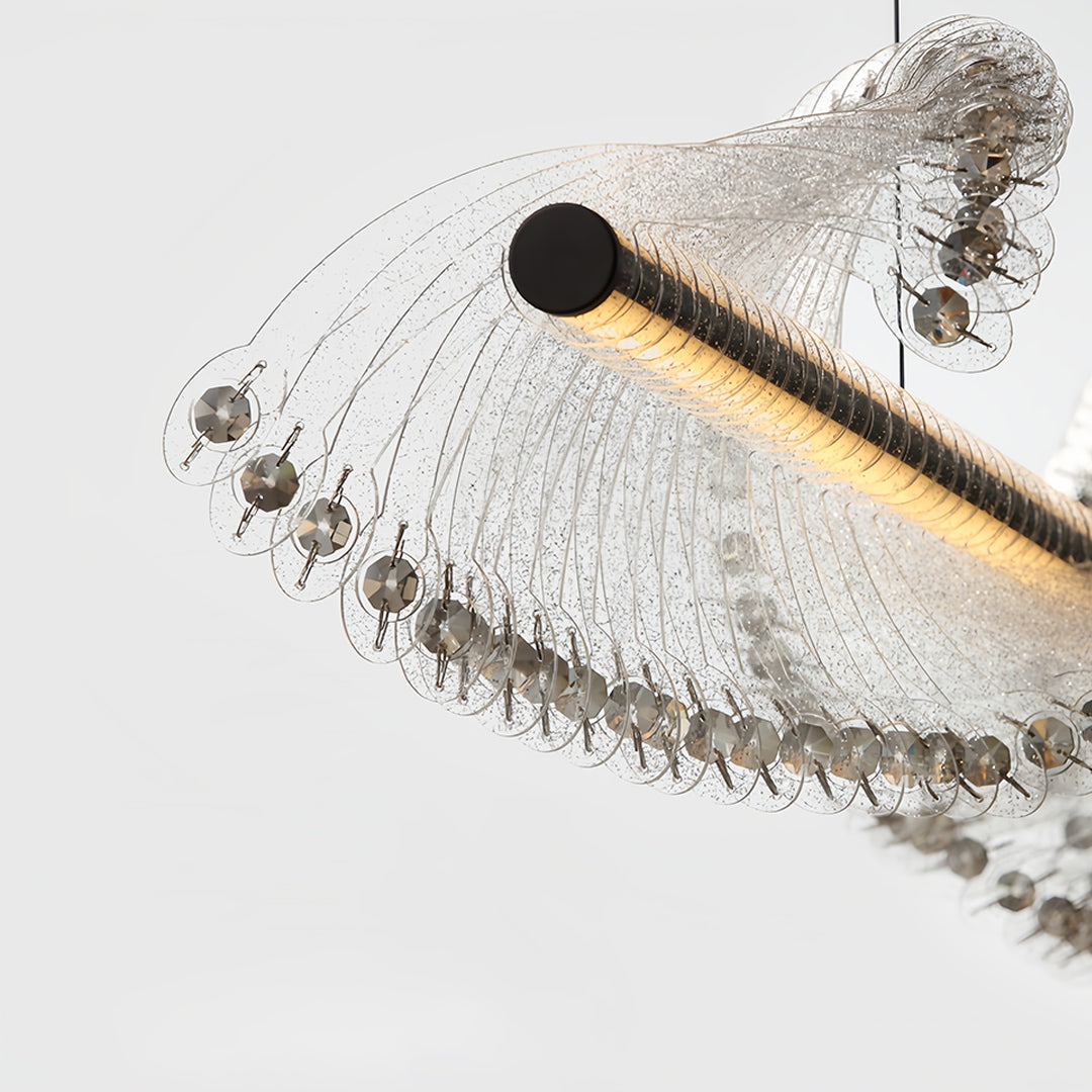 Artistic spiral chandelier displaying flowing wave design with suspended crystal drops creating dynamic lighting effects