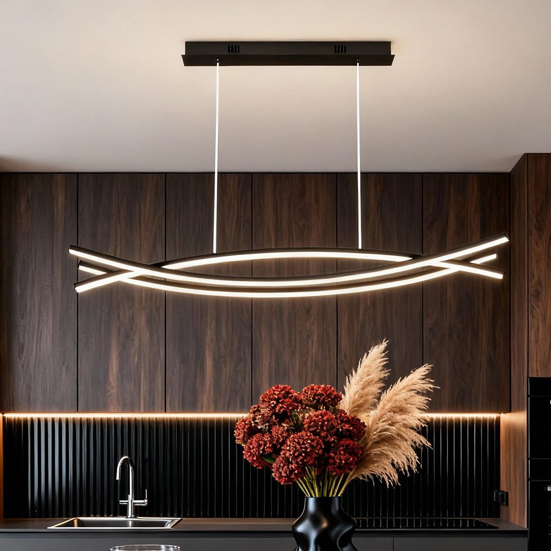Wave hanging light installed above a modern dining table