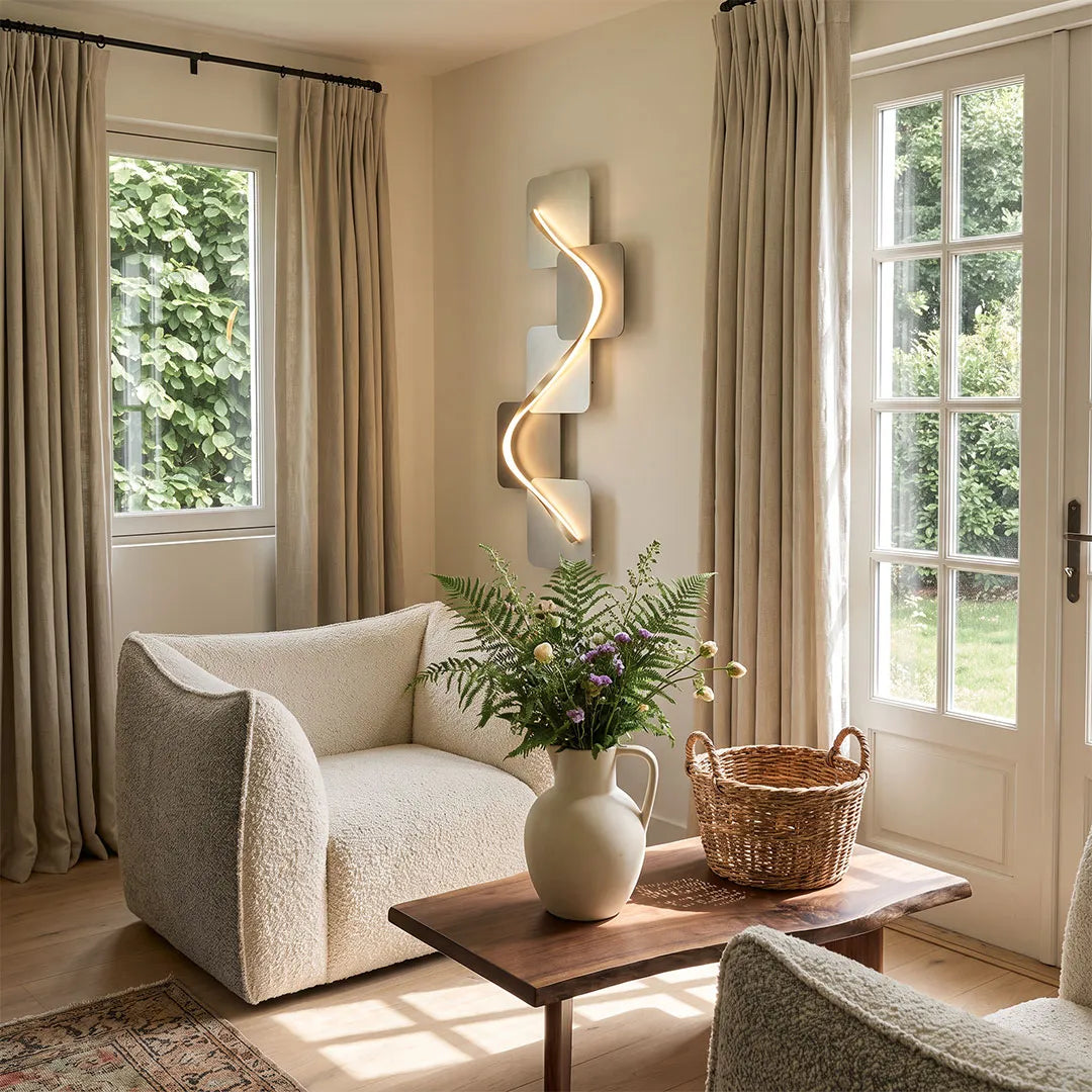 Wave pattern wall sconce in a bright living room with a curved sofa, wood coffee table, and soft neutral decor.
