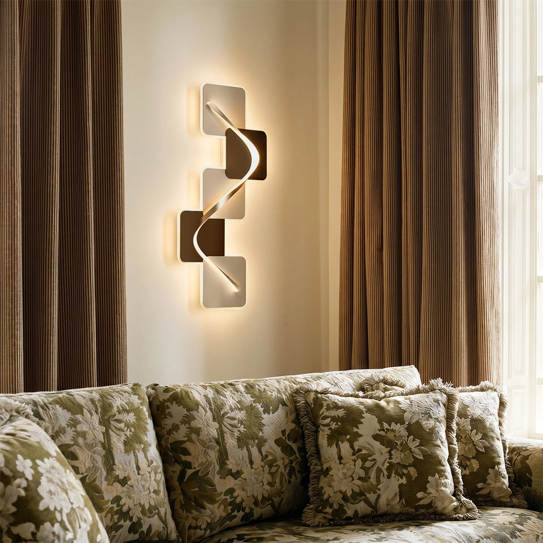 Wave pattern wall sconce mounted beside curtains above a sofa, adding warm ambient light.