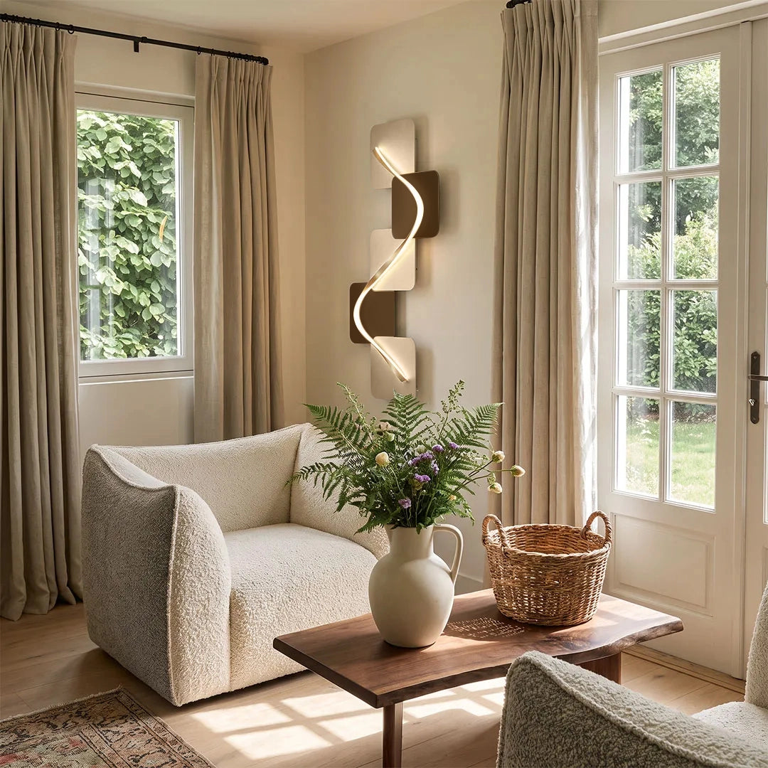 Wave pattern wall sconce mounted in a sunlit living room with large windows and neutral seating.