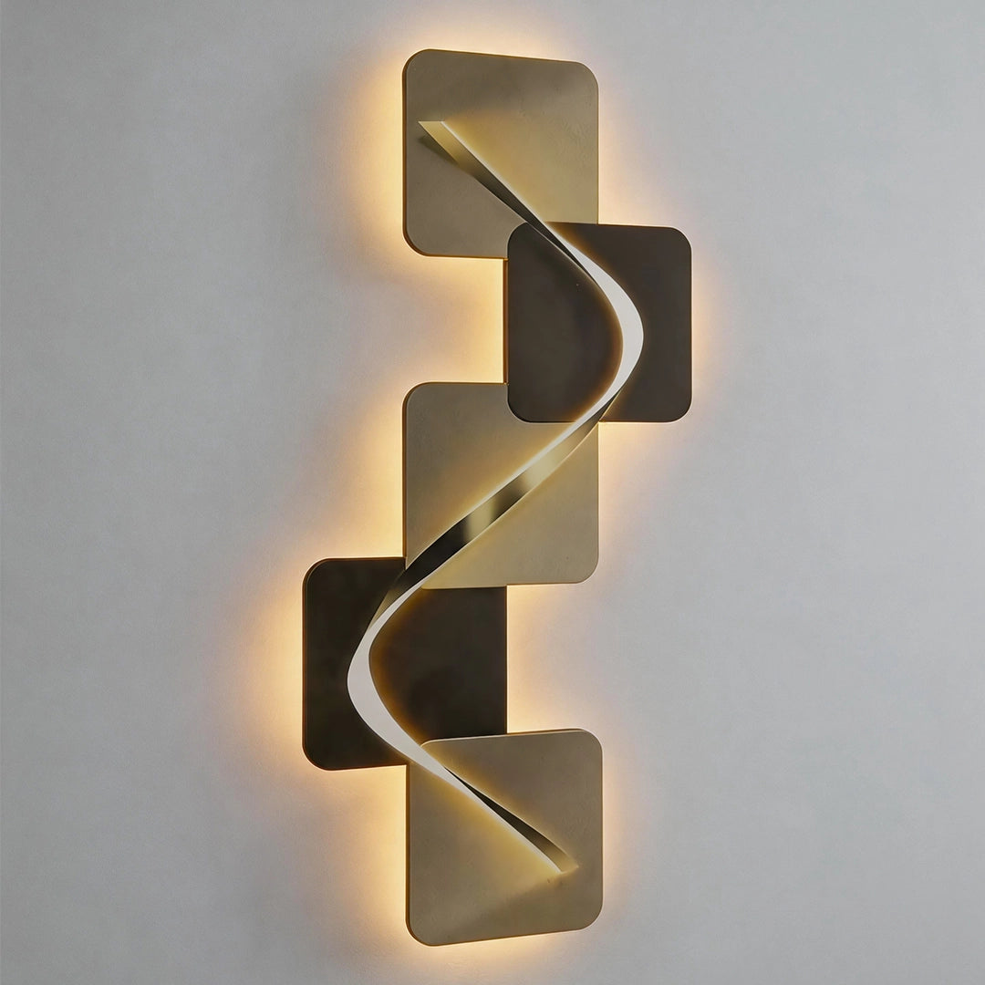 Close-up of a vertical wave pattern wall sconce with layered square panels and warm backlight.