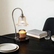 Wax melt light with elegant glass shade illuminating a cozy home office desk.