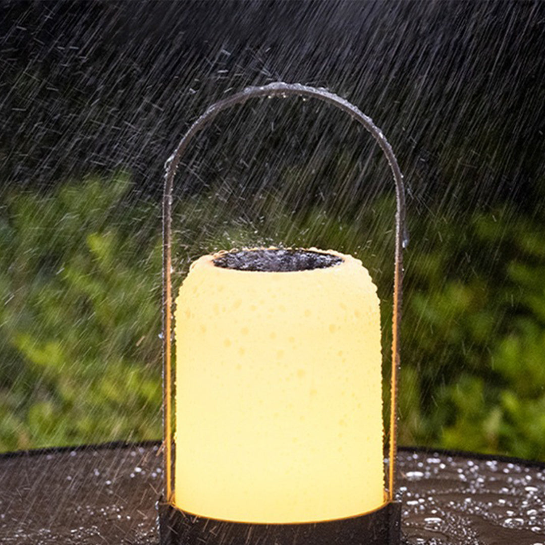 Weather-resistant LED lantern glowing softly in rain showing durable outdoor performance capability