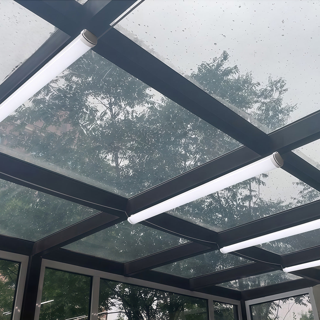 Weatherproof linear outdoor wall lighting modern tubes installed on the frame of a wet glass canopy.