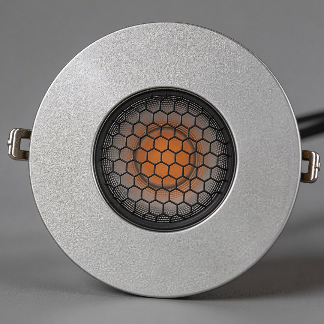 Close-up of well lights in concrete showcasing its stainless steel finish.