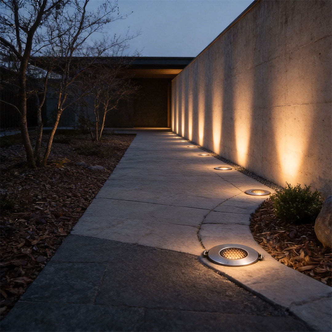 Well lights in concrete with a contemporary design, providing soft illumination near a wall.