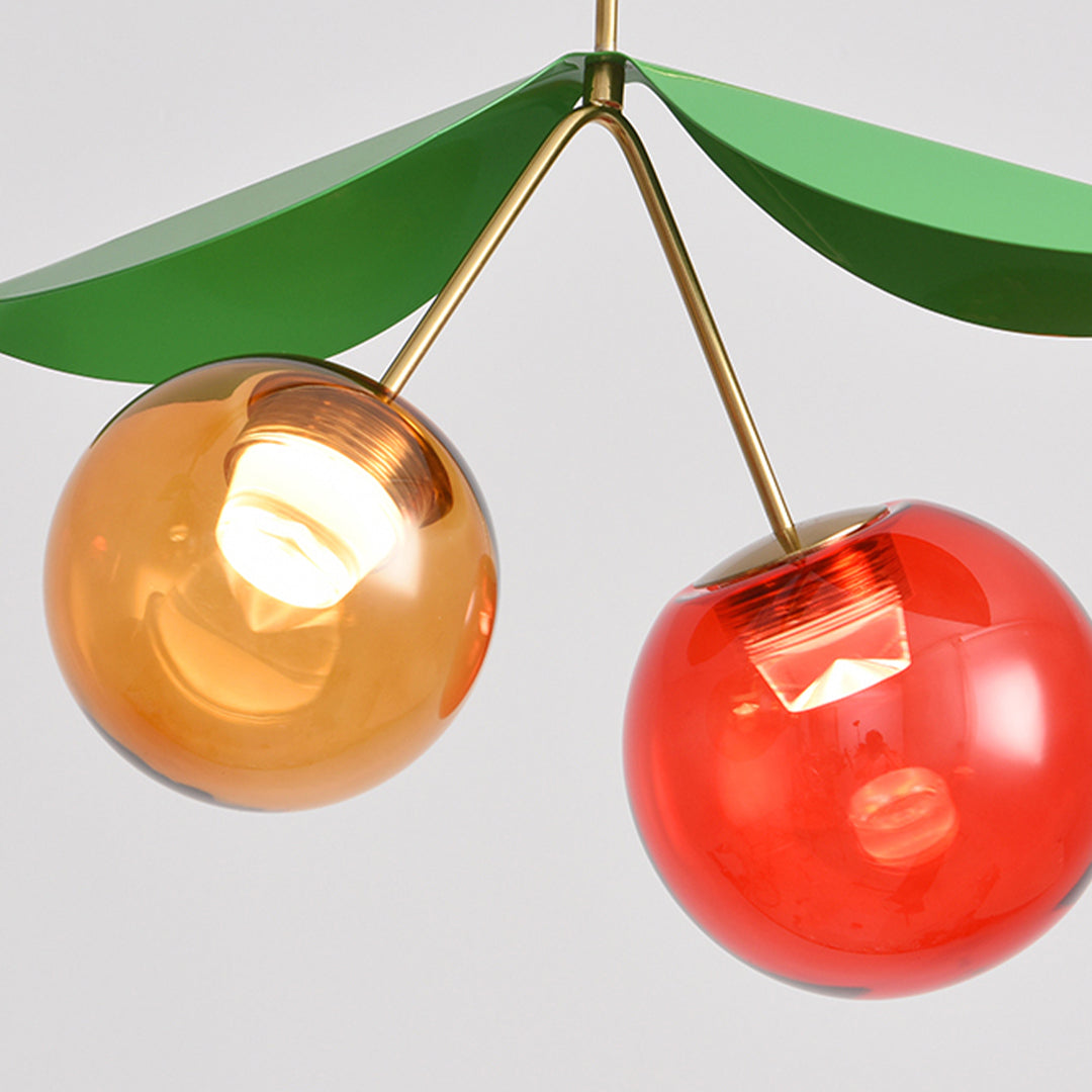 Whimsical modern LED table lamps featuring cherry-shaped glass orbs suspended from brass frame