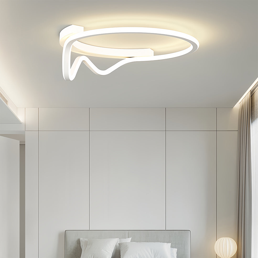 White abstract loop geometric flush mount light fixture installed in a minimalist white bedroom, providing gentle ambient light.