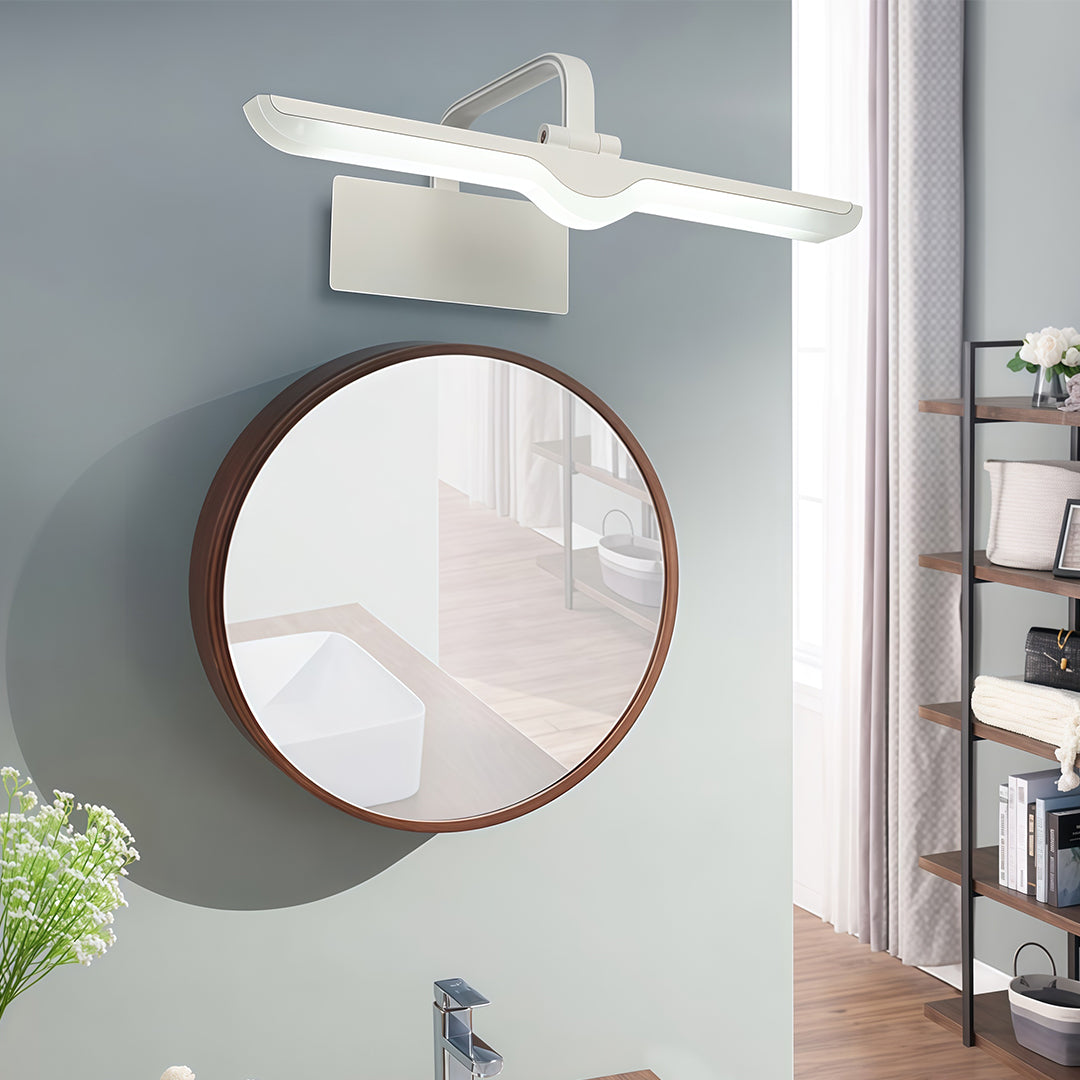 White bathroom vanity light installed above circular mirror on grey wall in contemporary bathroom.