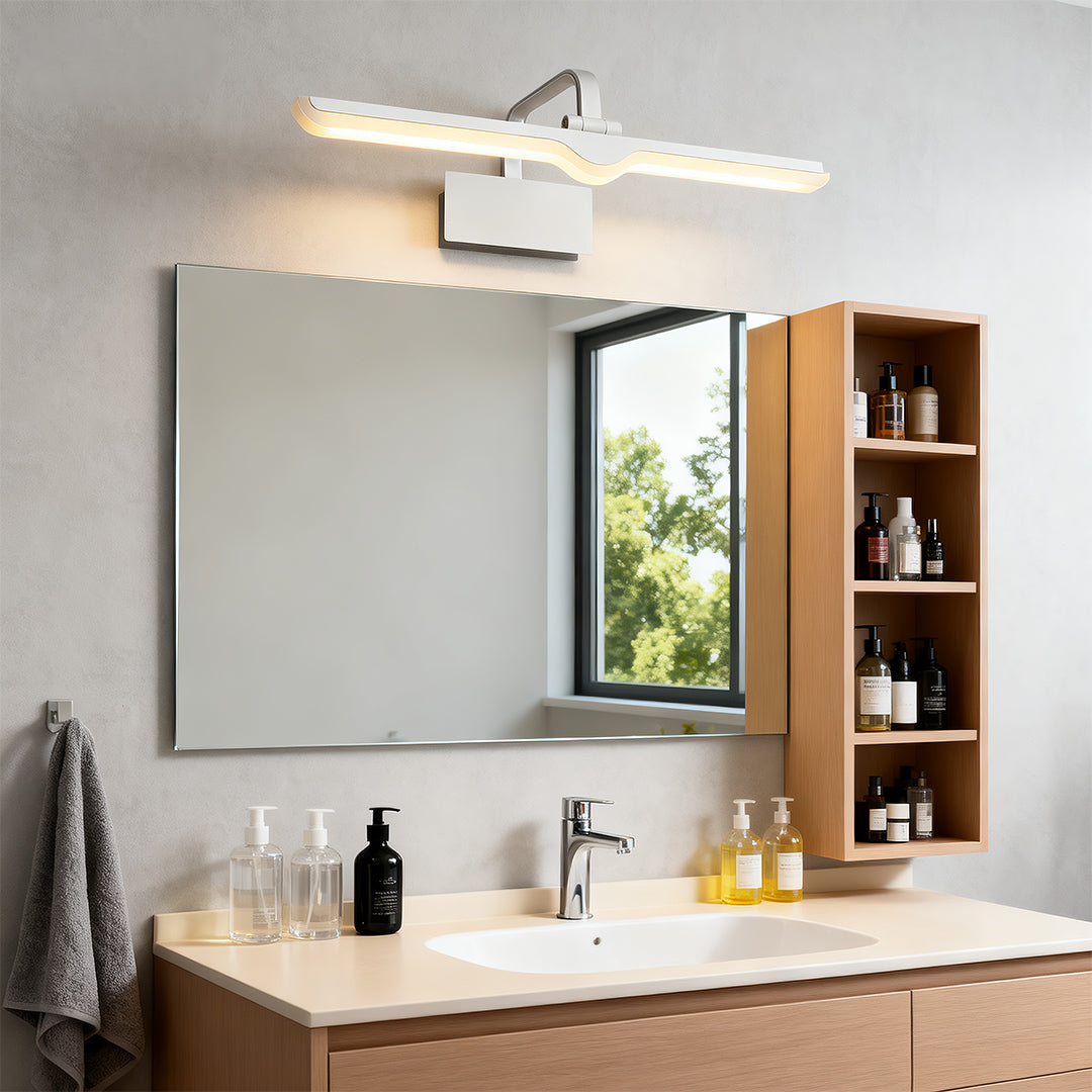 White bathroom vanity light illuminating modern bathroom with wood shelving and large mirror.