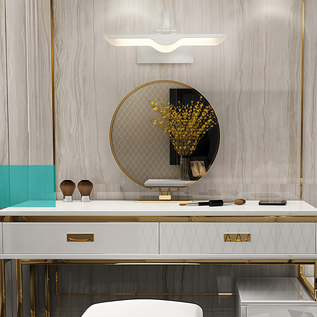 White bathroom vanity light providing task lighting in neutral bathroom with wood and marble accents.